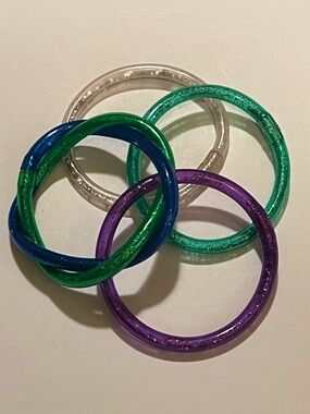 LOT OF 4 KID’S COLORFUL JELLY BRACELETS.